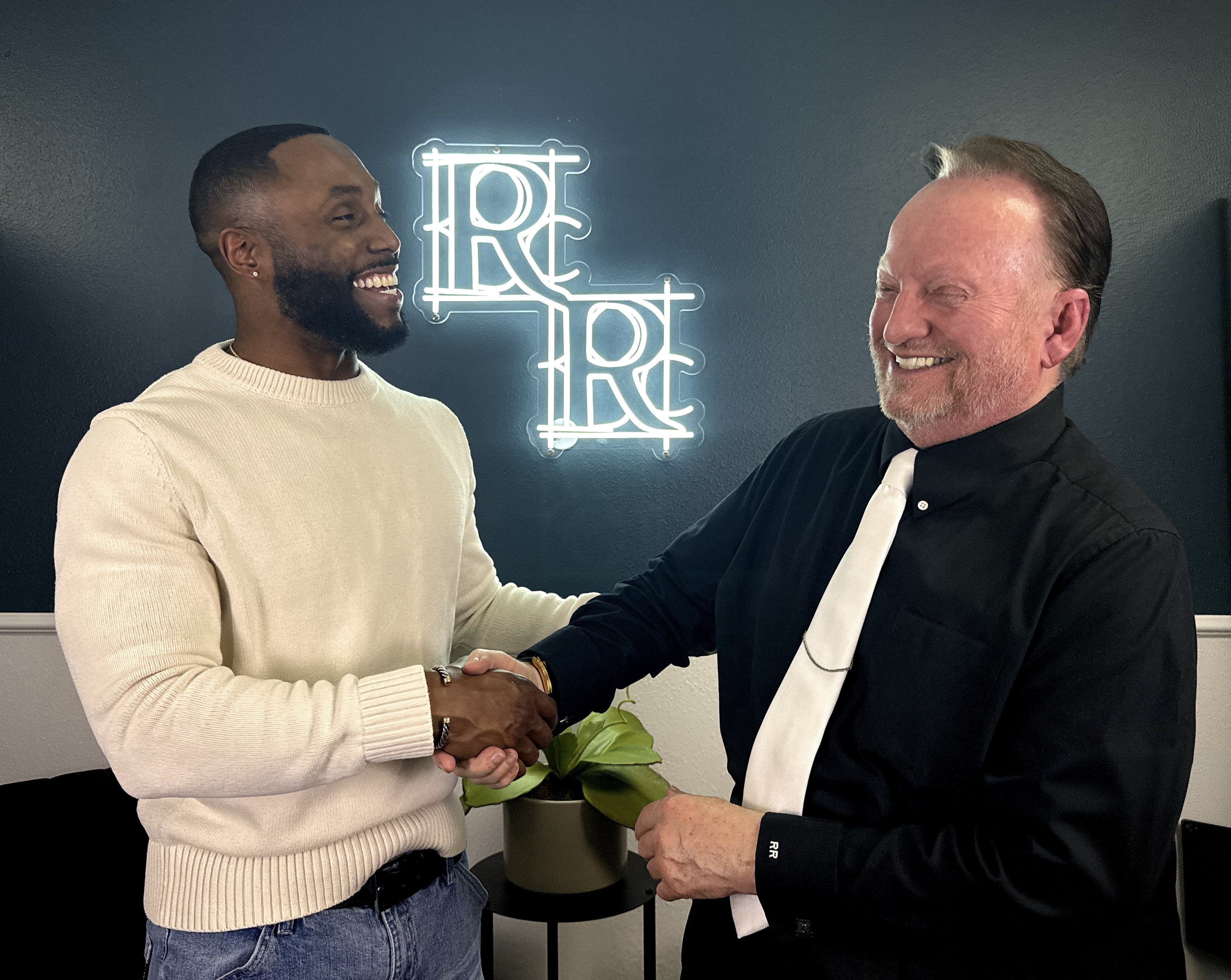 Ray Reynolds shaking hands with a client inside the office